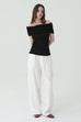 Noir off-shoulder knit in black