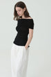 Noir off-shoulder knit in black